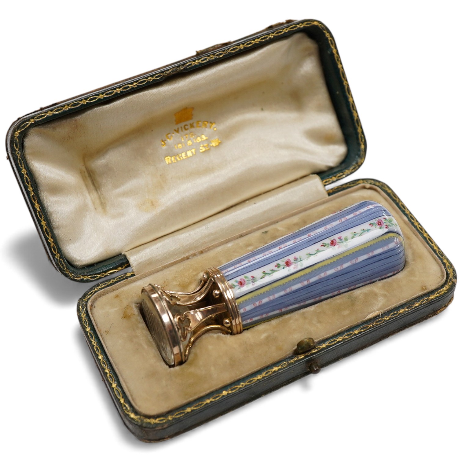 A late 19th century yellow metal and polychrome enamel desk seal, with rock crystal matrix, carved with a monogram, 69mm (small chip to the enamel), in original J.C Vickery fitted gilt tooled leather box.